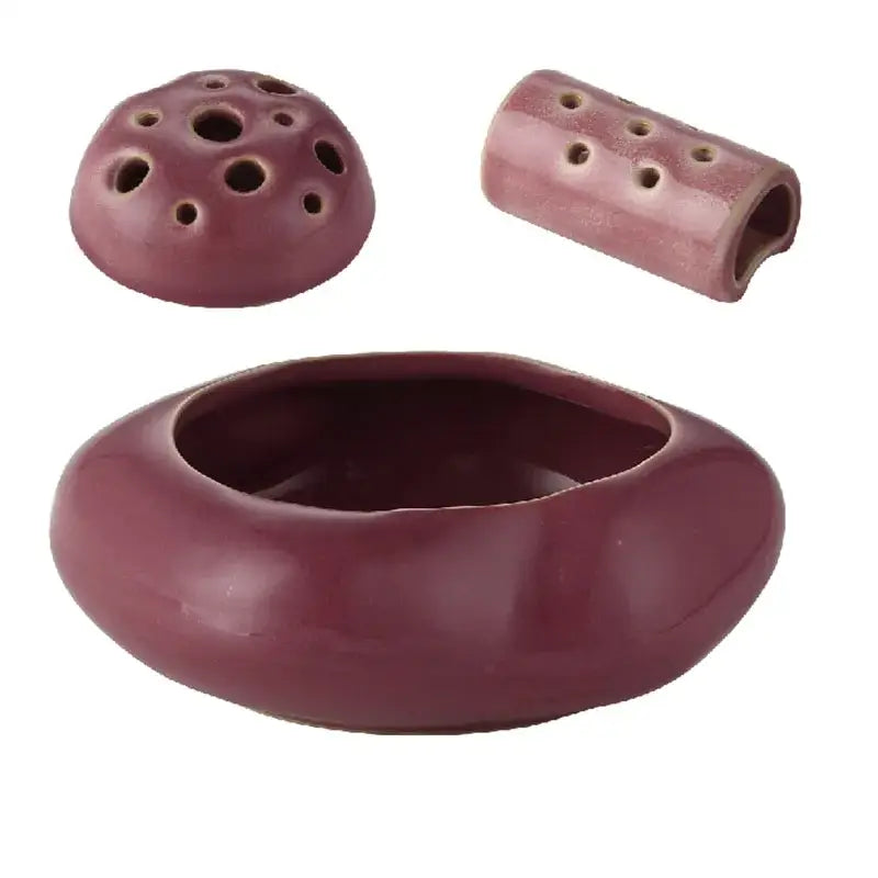 Maroon lotus seedpod ceramic incense burner set with rounded base, perforated lid, and cylindrical component for decor