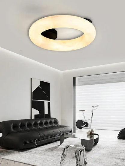 Modern elegant alabaster marble ceiling chandelier with a sleek black inner ring and warm diffused glow for living room