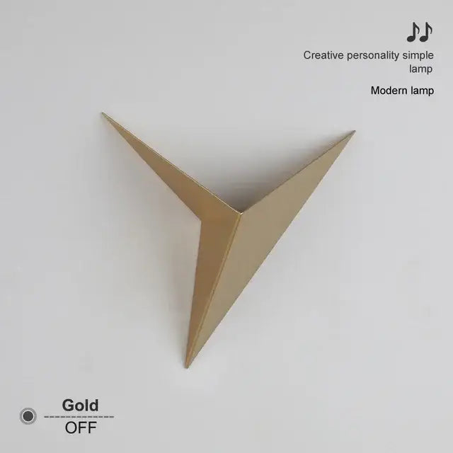 Modern elegant triangular led wall lamp in gold with sleek geometric design perfect for bedroom or study decorbites elegant triangular wall lamp