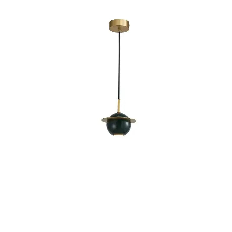 A modern emerald green marble led pendant lamp with a deep green spherical shade and brass accents for dining room use