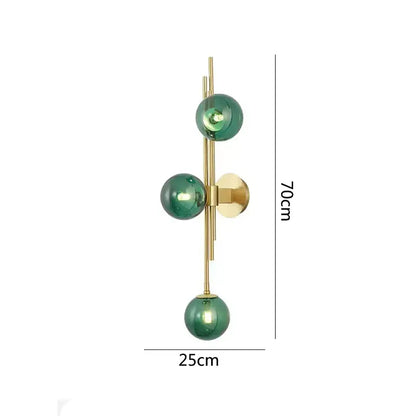 Modern emerald green white glass wall lamps featuring three green white glass spheres on a gold-toned frame for decorbites