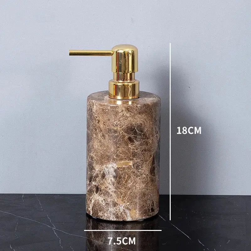 A cylindrical brown emperador dark marble soap dispenser with a polished gold-tone pump for bathroom use