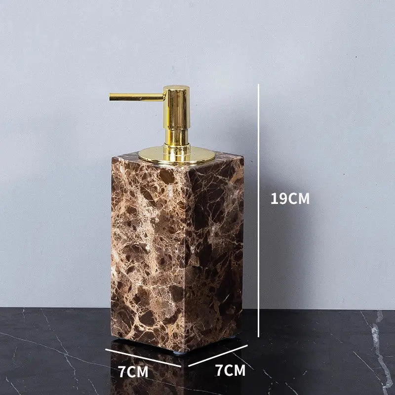 Brown marble soap dispenser with gold-tone pump in modern emperador dark marble bathroom set with chrome accents