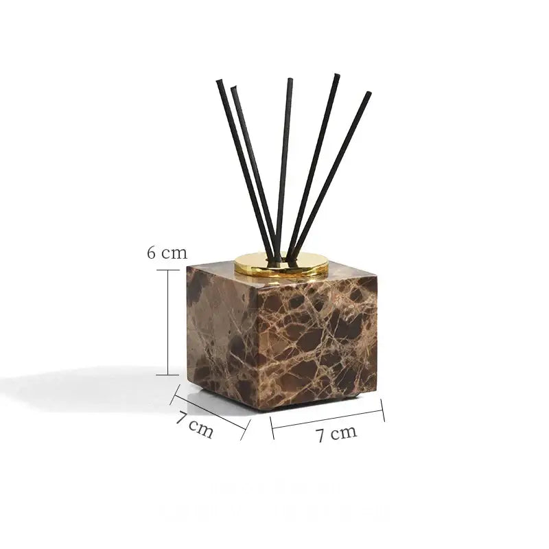 Brown emperador dark marble cube diffuser with gold-toned base and black reeds from modern bathroom set with chrome accents