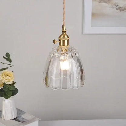 Modern faceted clear glass pendant lamp with brass fixture and braided cord featuring a knob switch by decorbites clear glass
