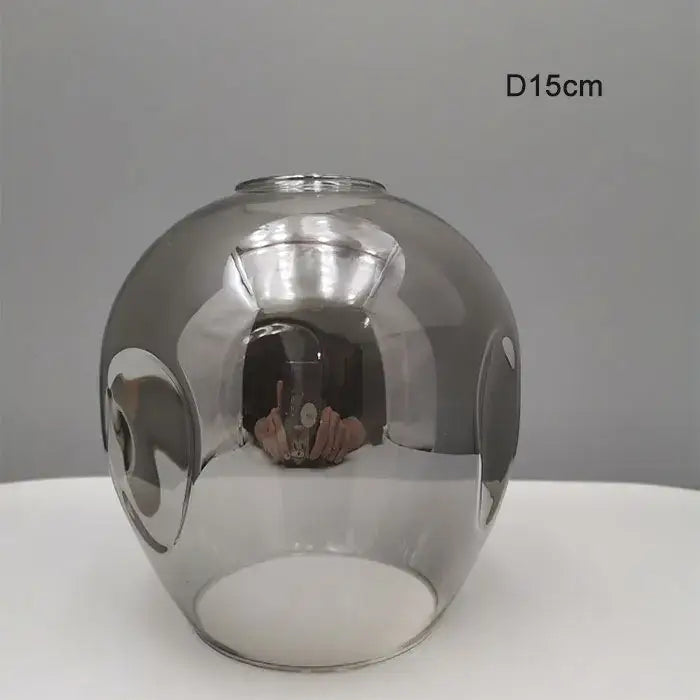 Modern faceted glass shade replacement with a reflective metallic finish and cut-out patterns for living room lamp cover