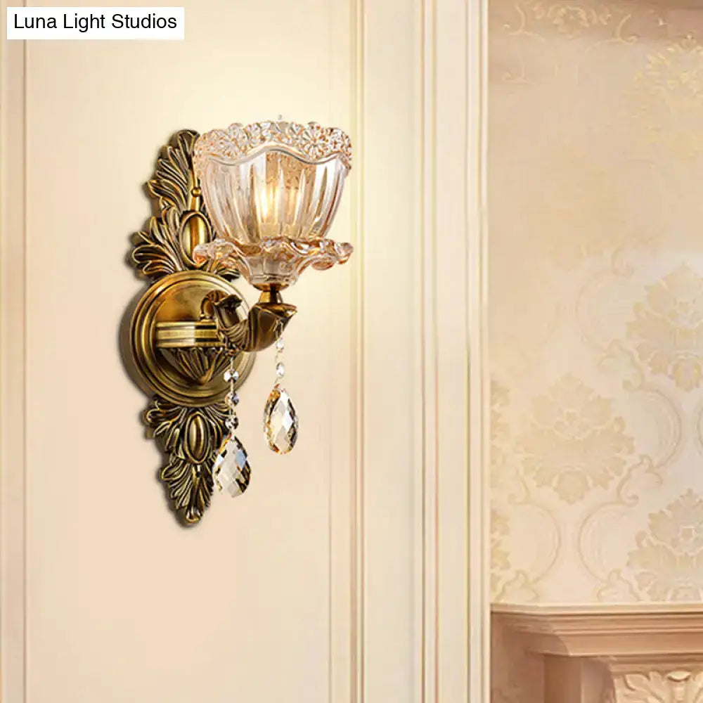 Antique brass modern floral wall sconce with teardrop crystal drop and amber faceted glass shade for living room