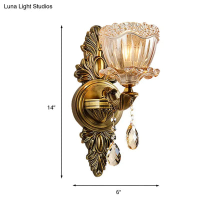 Antique brass ornate modern floral wall sconce with faceted amber glass shade and teardrop crystal drop for living room