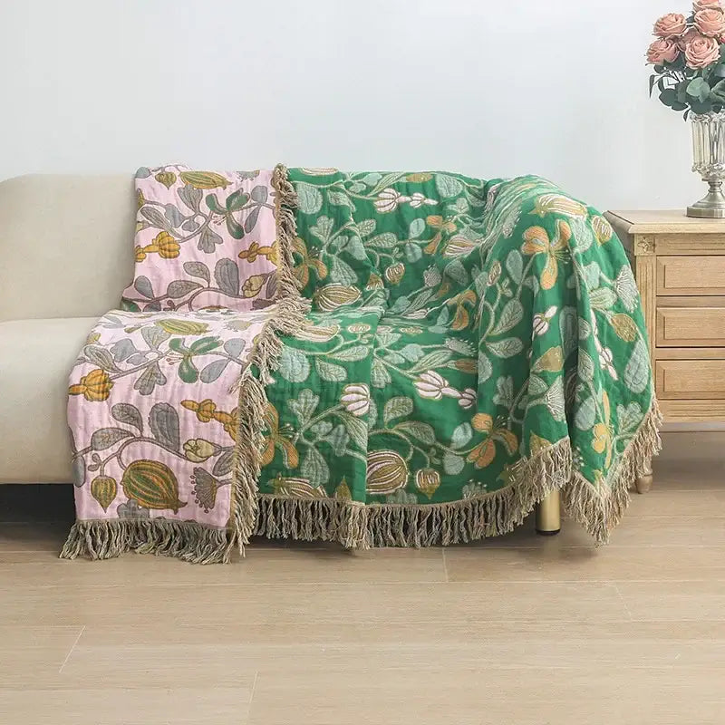 A cozy green and pink floral decorbites cooling cotton blanket with fringed edges for bedroom use