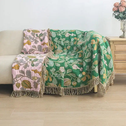 A cozy green and pink floral decorbites cooling cotton blanket with fringed edges for bedroom use