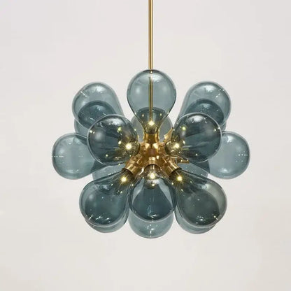 A modern teal glass ball pendant light with brass hub and floral design ideal for dining room decorbites decor