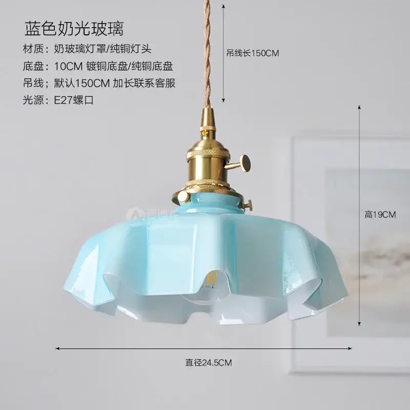 A delicate light blue frosted glass pendant light with brass base ideal for modern dining room lighting