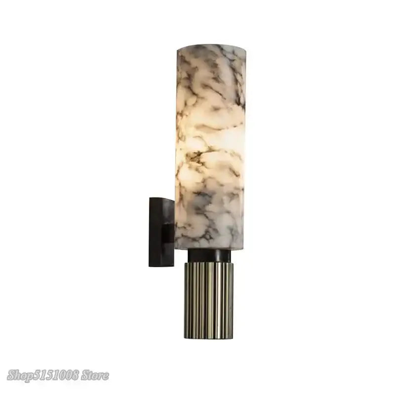 Elegant cylindrical wall light with decorbites dolomite marble translucent shade and fluted metallic base for bedroom use