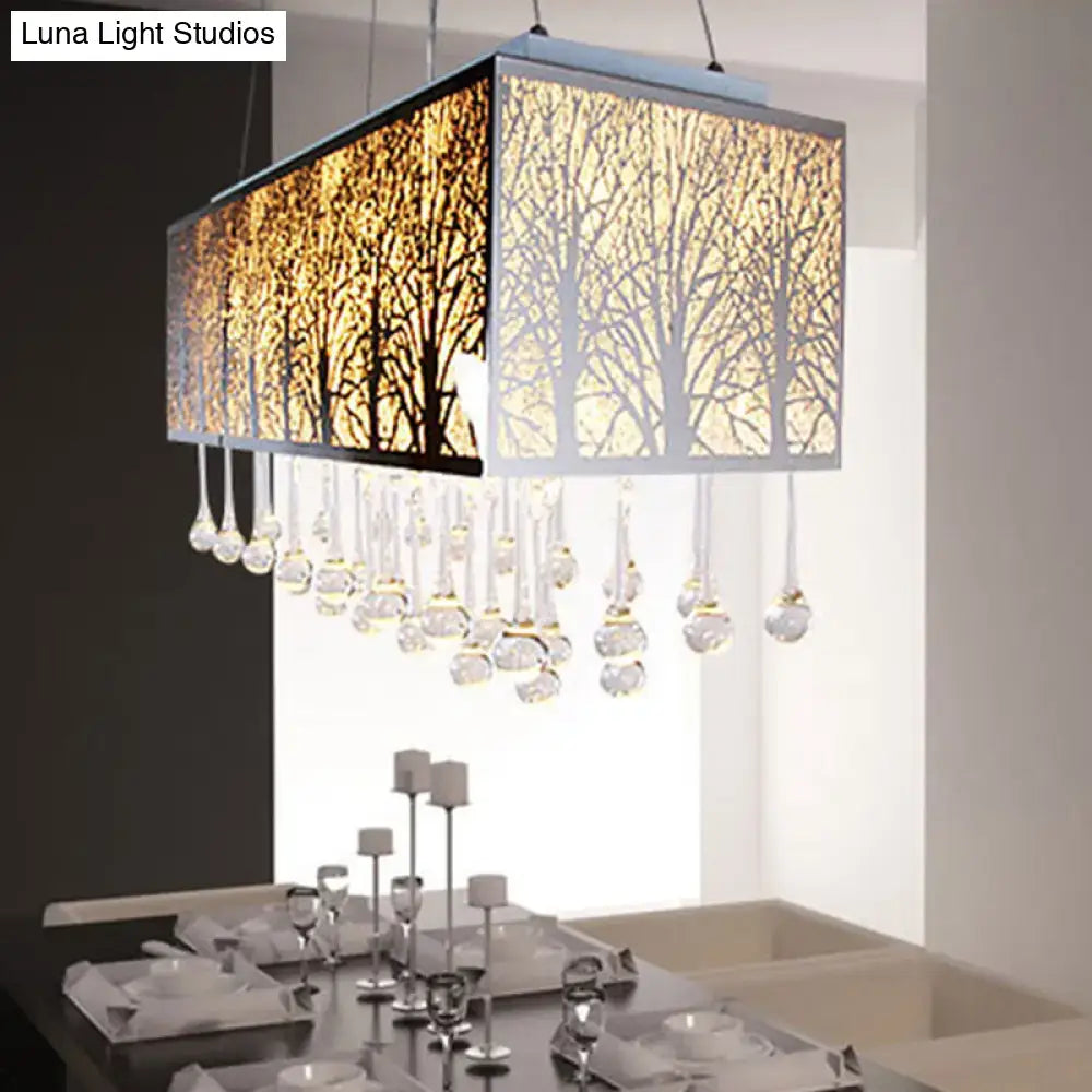 Rectangular island light with metallic frame featuring amber and white forest pattern and dangling waterdrop crystals
