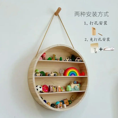 Light-colored modern four tier circular wooden frame wall shelf with three shelves and hanging rope attachment