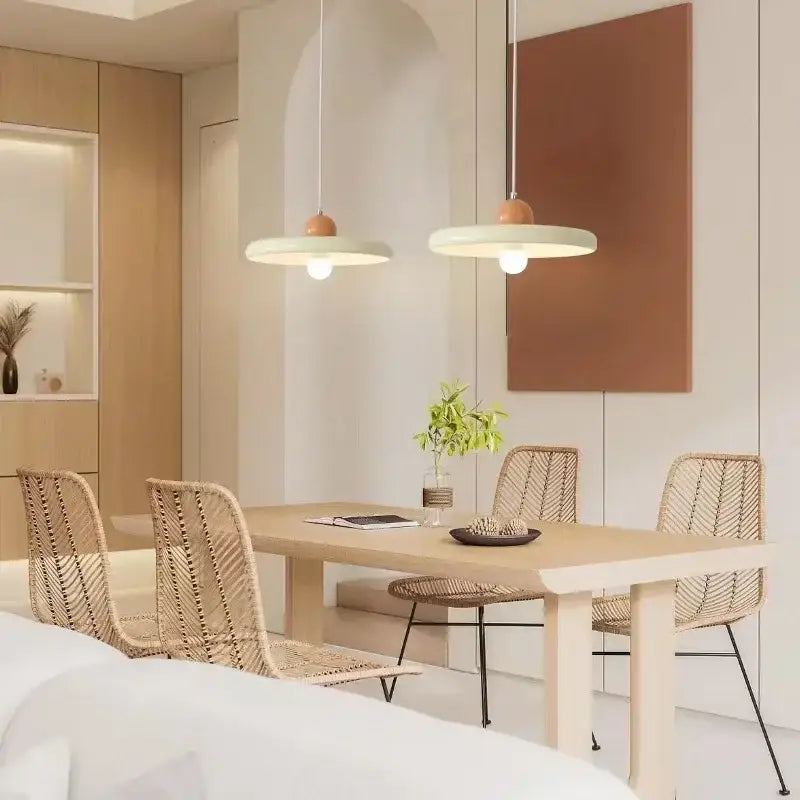 Modern french cream metal pendant light with matte white shades and wooden accents for dining room use