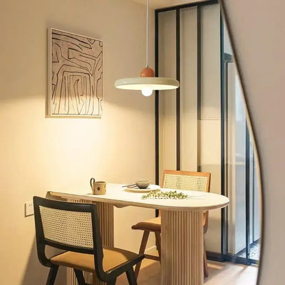 Modern french cream metal pendant light with matte white circular shade and orange center accent for dining room lighting