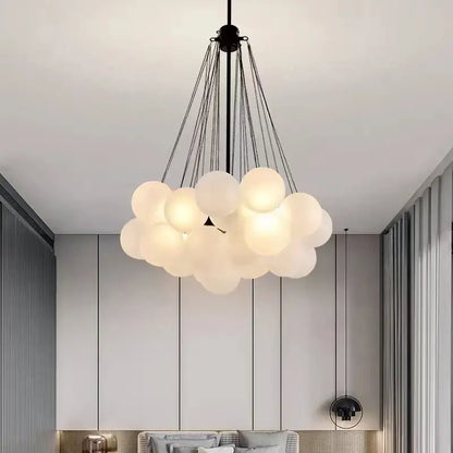 Modern pendant lights featuring frosted glass ball globes shaped like clouds suspended by black chains for dining room use