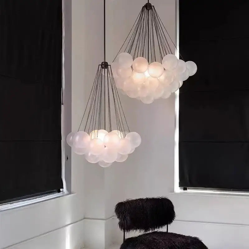 Modern frosted glass ball cloud pendant lights with translucent frosted glass spheres and dark metal chains for dining room