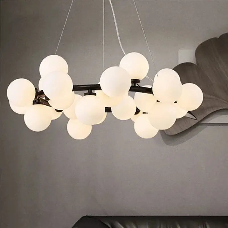 Modern frosted glass ball led chandelier with multiple white spherical glass globes on dark metal frame for dining room decorbites glass ball
