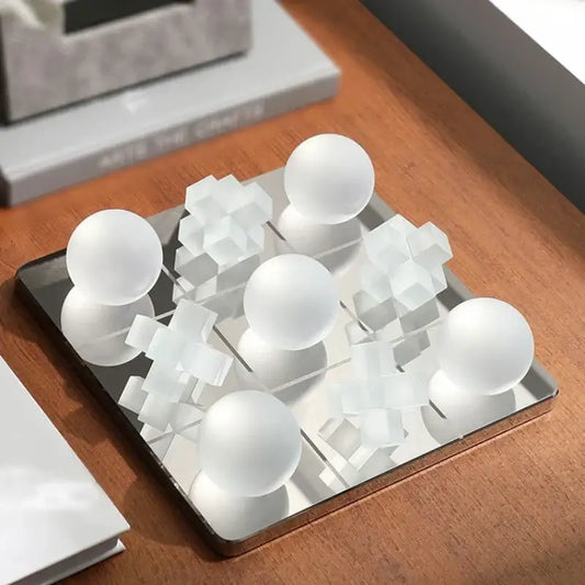 Modern frosted glass geometric tic tac toe set with white frosted spherical and cube pieces on mirrored glass geometric chessboard decorbites frosted glass