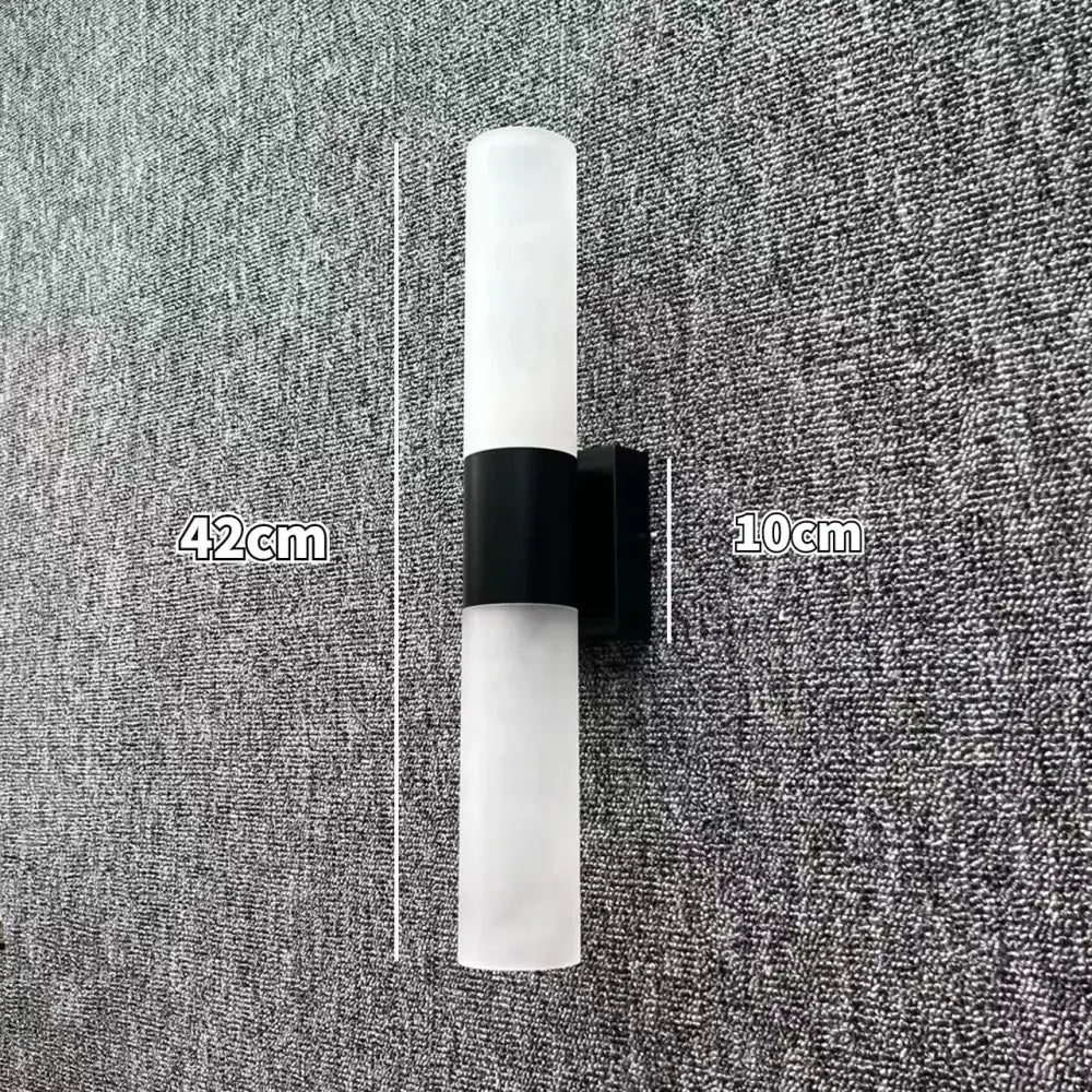 Modern minimalist led wall lamp with frosted glass cylinder and black metal bracket for bedroom sconce lighting
