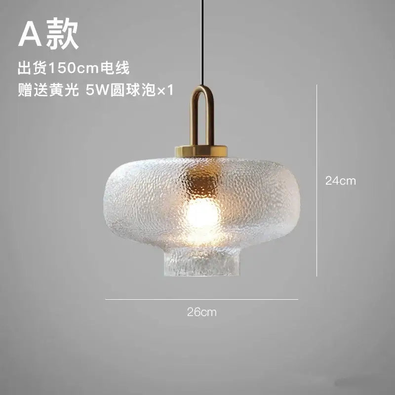 Modern frosted glass pendant lights with textured glass and brass finished metal fixture for kitchen use