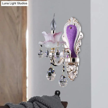 Elegant frosted glass purple wall sconce with teardrop crystal droplets and ornate silver floral metalwork for bedroom