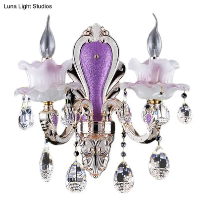 Elegant purple and silver ornate glass purple wall sconce with frosted glass purple shades and teardrop crystal droplets
