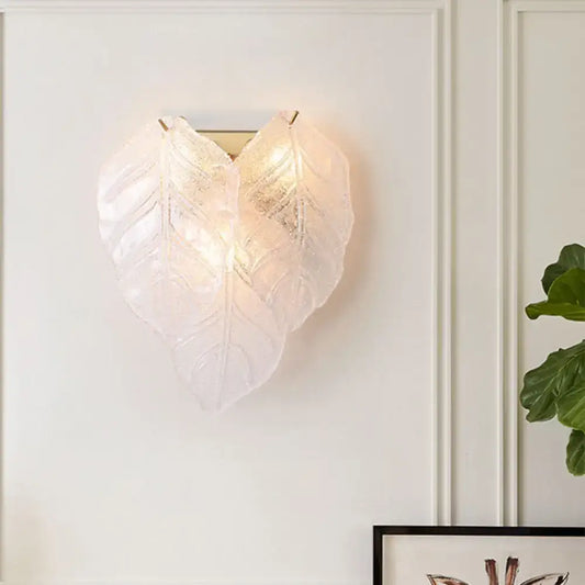 Modern frosted white glass leaf wall sconce light with translucent overlapping leaves and visible veining design