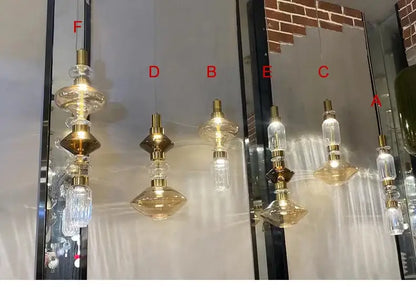 Modern geometric amber and clear glass chandelier with gold-toned pendant lights featuring faceted crystal accents from decorbites glass chandelier collection