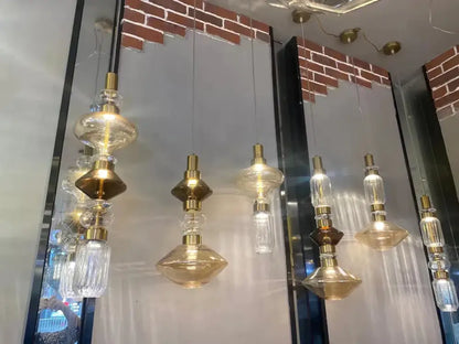 Modern geometric amber and clear decorbites glass chandelier with gold-toned glass and brass accents for dining room lighting