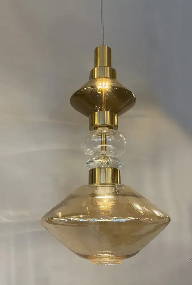 A modern pendant light with a gold-toned metal frame and amber-tinted glass shades decorbites glass chandelier