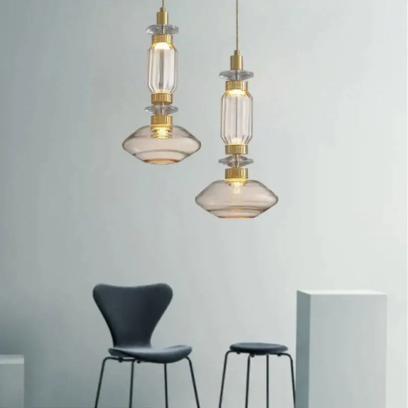 Two elegant decorbites glass chandelier pendant lights with smoked glass shades and gold accents for dining room decor