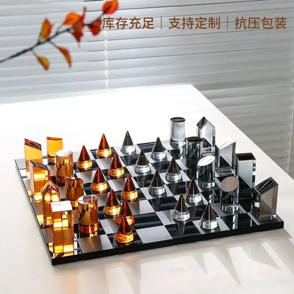 Modern glass chess set with amber and silver geometric design on mirrored board for stylish home decor use