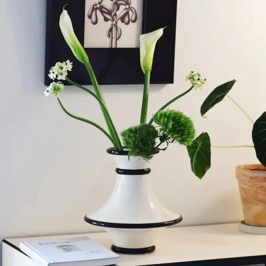 Modern geometric black and white stripes ceramic vase with black rim accents holding calla lilies for decorbites geometric black decor