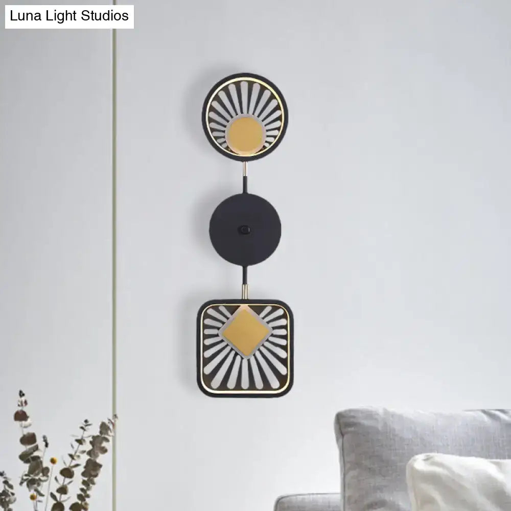 Modern geometric black and gold wall lamp with sunburst design and three stacked circular elements for living room use