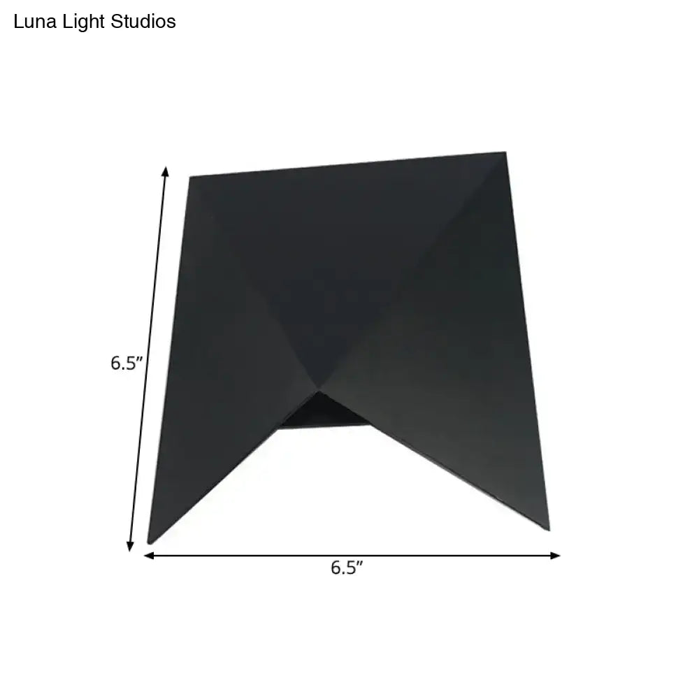 Modern geometric black metal wall sconce with sleek angular design for bedroom wall lamp illumination