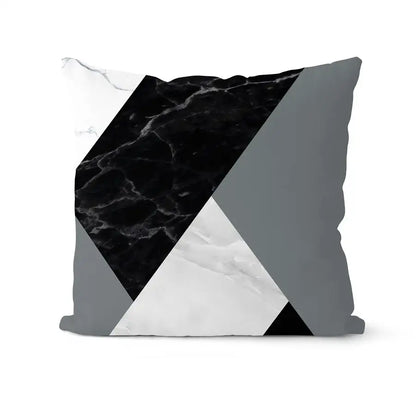 A modern geometric black and white pillowcase set featuring bold black marble white marble and gray triangular panels