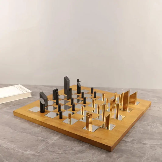 Modern geometric block chess set with a wooden board and gold and black metallic pieces for decorbites living room decor