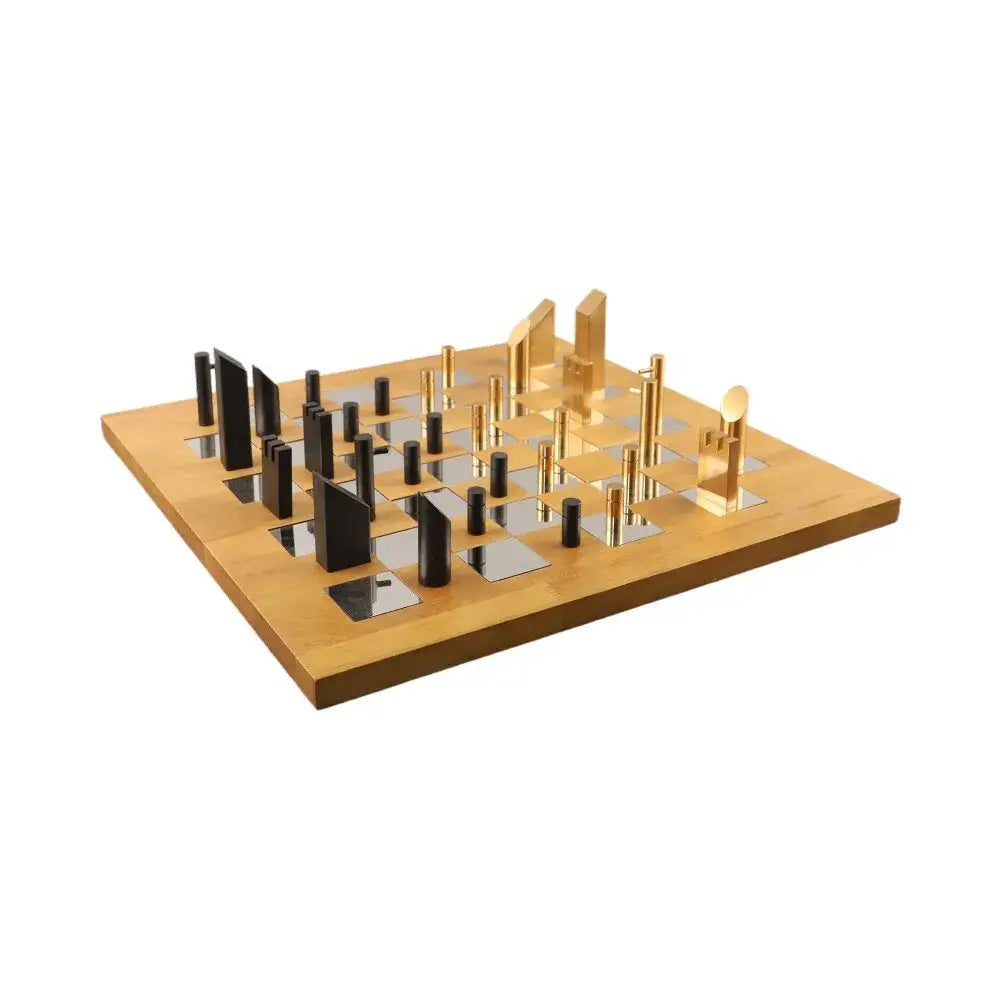 Modern geometric block chess set featuring a light wood board with black and silver mirrored squares and gold black pieces decorbites geometric block chess