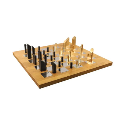 Modern geometric block chess set featuring a light wood board with black and silver mirrored squares and gold black pieces decorbites geometric block chess