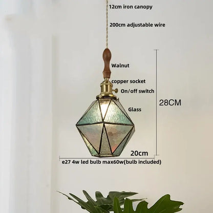 Modern geometric pendant light with blue glass panels, walnut wooden top, and copper socket for dining room decorbites blue glass