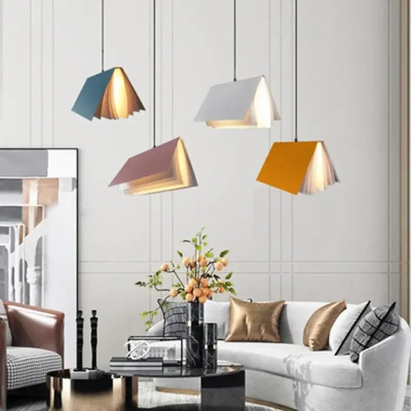 Modern geometric book pendant lamp with teal white mauve and mustard layered paper panels for bedroom lighting decorbites book pendant
