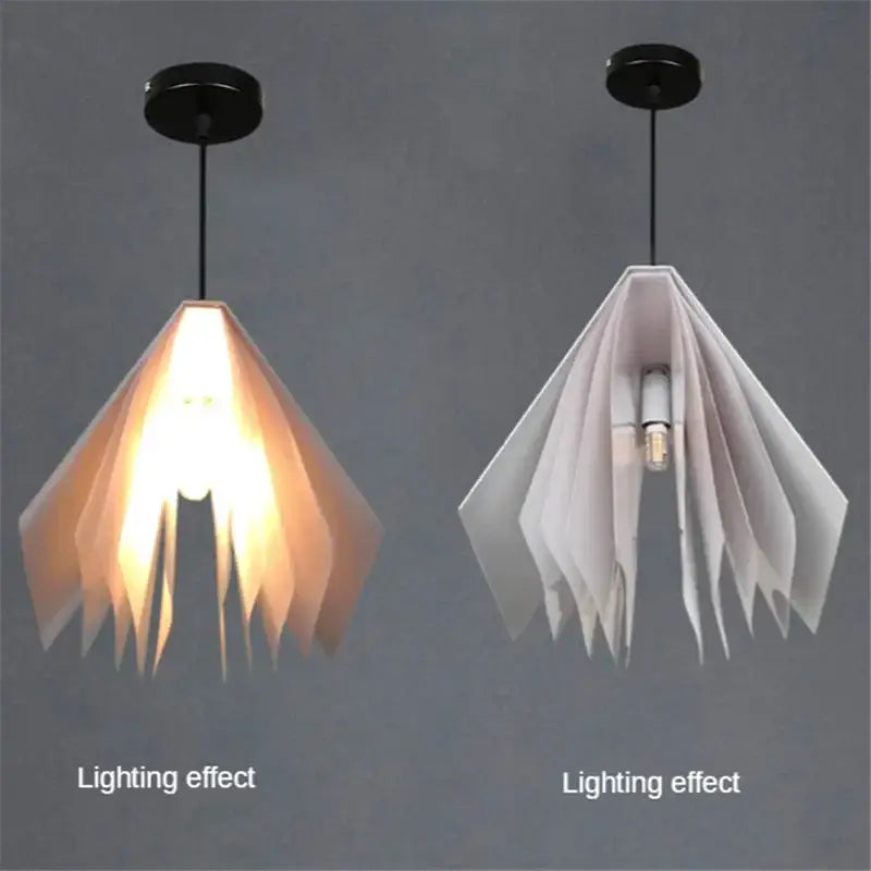 Two modern geometric decorbites book pendant lamps with layered paper panels in amber and white for bedroom lighting