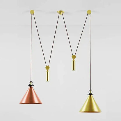 Two conical pendant lights with copper and gold finishes hang from adjustable black cords in a dining room pendant light