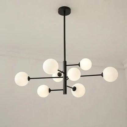 Modern geometric decorbites brass chandelier featuring black metal frame with frosted white glass globes for living room decor