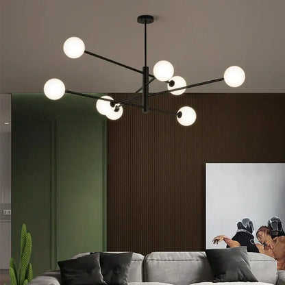 Modern geometric decorbites brass chandelier with black metal frame and frosted glass globe lights for living room decor