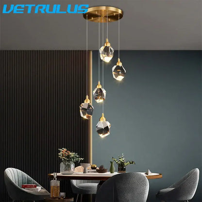 Gold-toned modern geometric brass pendant light with five faceted diamond crystal led shades for dining room chandelier