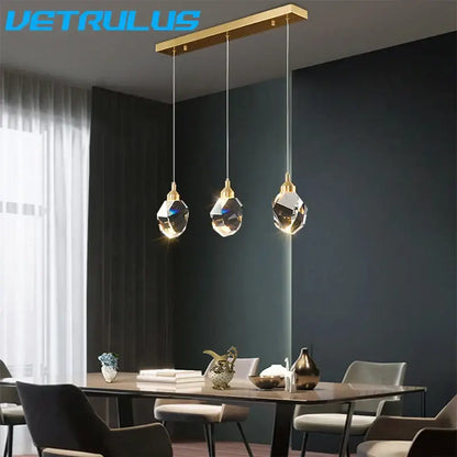 Gold-toned rectangular pendant light with three hanging diamond crystal led lights for modern dining room chandelier